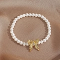 Elegant pearl butterfly bracelet featuring gold accents and rhinestones on silk - White Pearl Butterfly Bracelet (0103-White)
