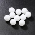 Polished white crystal stone spheres set of ten pieces on black textured surface - Agate