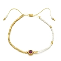 Detail of beaded bracelet with red zircon, golden beads and adjustable cord - Deep purple