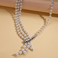 Detail of three-layer pearl necklace with silver irregular metallic lava connector - Silver