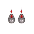 Close-up of vintage silver boho earrings with red teardrop stones and carved details - Retro Silver Red Drop Earring
