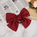 Elegant wine red satin oversized bow hair clip shown on a white marble background - Hair Tie / Burgundy