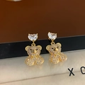 Close-up of teddy bear earrings with sparkling crystals and a heart-shaped zircon stone - White Zircon Gold (Silver Needle)