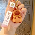 Cute brown capybara silicone keychain with pink BOOM strap and golden lobster clasp - Capybara - Classic Style