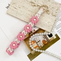 Pink daisy crochet keychain with wooden beads and wrist strap on an elegant background - White + Pink