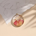 Round resin pendant with pink dried flower petals and gold leaf in a golden metal frame - Heart Pink/Gold