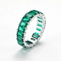 Close-up of eternity ring with rectangular emerald green zircons in silver claws - Silver With Green Zircon
