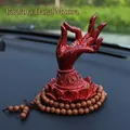 Car dashboard ornament featuring a Buddha hand on a red lotus base with prayer beads - Universal Buddha Hand