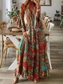 Detail of bohemian maxi dress showing V-neckline with tassels and vibrant ethnic patterns - S / Orange