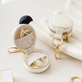 Mini round portable cream jewelry organizer with gold zipper and ring storage - Off White