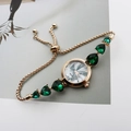 Detail of gold quartz watch with green heart gemstones and marble pattern dial - Rose Gold Green