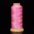 Pink nylon beading thread on yellow spool for handmade jewelry and DIY weaving - Pink