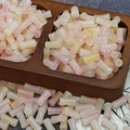 Macro detail of 6x12mm gradient bamboo-shaped glass beads in pink and yellow hues - Pearlescent Triple Gradient (J114#)