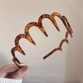 Brown tortoise shell wavy hairband with non-slip teeth for secure hair styling - Glossy Resin Style / Amber Wave Hairband
