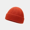 Close-up of orange knitted docker hat featuring detailed ribbed texture and cuffed brim - One Size / Orange