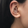 Minimalist gold ear crawler with zircon rings shown on model in a sleek close-up shot - Circle Ring Style (DZ-715)