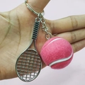 Detail of pink felt tennis ball and silver metal racket keychain held against pink wall - 3.8cm Ball / Pink