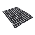 Close-up of soft black flannel blanket featuring a repeating white skull pattern - Black Skull Array
