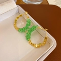 Macro detail view of elegant green crystal and gold beaded hoop earrings in jewelry box - Gold Large Hoop Green Glass Bead Earrings (9#) / Gold Green