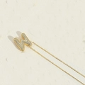 Golden bubble letter W pendant necklace with pavé cubic zirconia on a delicate chain - M