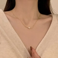 Minimalist gold pearl pendant necklace featuring a curved bar design on model - X1128 Gold - Pearl Pendant