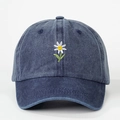 Navy blue washed denim baseball cap featuring daisy floral embroidery and adjustable strap - One Size / Navy Blue
