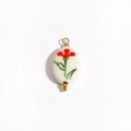 Close-up of white ceramic oval pendant with red floral patterns and 18K gold accents - Tulip Bud Shape (Style 6)