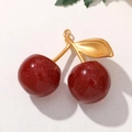 Macro shot of glittery dark red cherry charms with golden alloy leaf and hook attachment - Matte Gold Stem Red