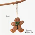 Gingerbread man Christmas ornament with green bow and white icing details, 8cm tall - Green Bow Gingerbread Man
