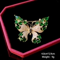 Detailed macro of a gold butterfly brooch with emerald gems and 4.0cm by 2.9cm dimensions - B1219/Green Wing Butterfly