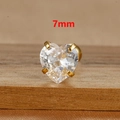 Macro shot of 7mm heart-shaped cubic zirconia stud earrings with gold claw settings - 1 Piece / 7mm / Gold
