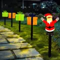 Solar Christmas light set featuring a Santa Claus and colorful gift box garden stakes - Santa with Gifts (Black Tube)