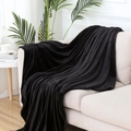 Soft black flannel fleece throw blanket draped on a cream sofa in a cozy room - Black / 120x200cm