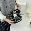 Close-up of black plush lamb wool crossbody bag with patterned shoulder strap - Ethnic Style Totem