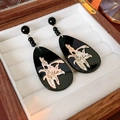 Detail of black teardrop earrings with beige abstract pattern in a wooden jewelry box - Black Teardrop Plant Texture Style