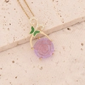 Golden butterfly and purple rose pendant necklace on textured stone background - Purple
