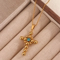 Collana vintage a croce dorata con ciondolo in zircone blu su vassoio portagioie beige - Zirconia Verde Chiaro