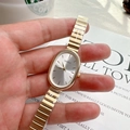 Elegant gold oval quartz watch for women with stylish metal chain strap on magazine - Gold Band White Dial
