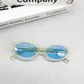 Flat lay detail of vintage oval sunglasses with green frames and blue lenses - Blue