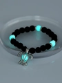 Luminous turtle charm bracelet with black lava beads and glowing blue accents - Turtle + Blue-Green Luminous