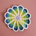 Handmade crochet coaster with purple center and blue-green gradient flower petals - No. 8 Gradient