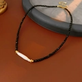 Macro detail of vintage French necklace with black agate beads and freshwater pearl accent - Necklace-Black-White