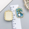 Detailed view of enamel cherry pearl pendant showing size with a ruler and golden back - Blue Gold-Sprinkled Square Pearl Cherry-23588