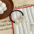 Detail of handmade acetic acid cream bow hair tie on a minimalist decorative background - Bow Style / Pearl White