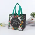 Black non-woven Easter gift bag featuring bunnies and colorful eggs with green handles - CBD10-Horizontal