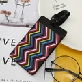 Black silicone luggage tag with colorful wave patterns and a durable black strap - Wave