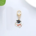 Metal graduation keychain featuring a black mortarboard, books, and scroll on a lobster clasp - Book Graduation Cap