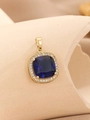 Macro shot of square blue zircon pendant with gold setting and surrounding small crystals - Gold Royal Blue