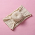 Macro detail of cream jacquard knit baby headband with a soft donut knot decoration - Dirty White