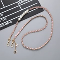 Detail of woven purple leather gold chain with pearls, camellia and jacket charms - Crossbody Chain / Light Purple